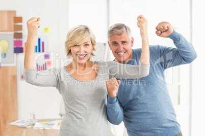 Happy business colleagues gesturing victory