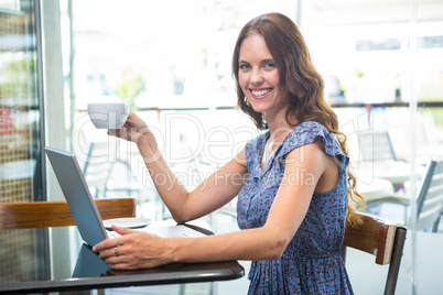 Pretty brunette using her laptop Pretty brunette using her laptop