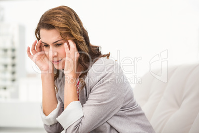 Overworked casual businesswoman having a headache