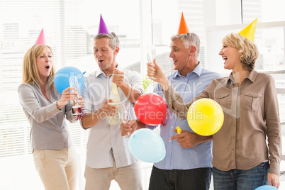 Casual business people toasting and celebrating birthday