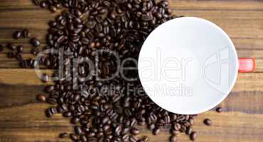 Coffee beans on a table with cup