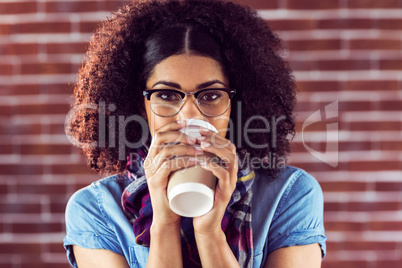 Attractive hipster drinking out of take-away cup