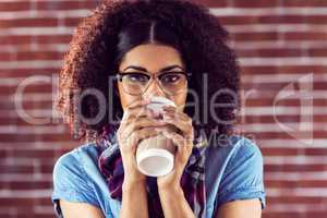 Attractive hipster drinking out of take-away cup