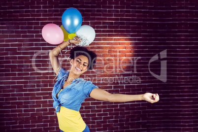 Young woman dancing with balloons