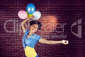 Young woman dancing with balloons