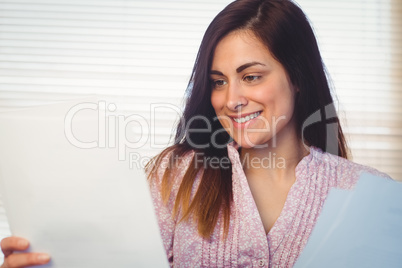 Pretty brunette reading documents