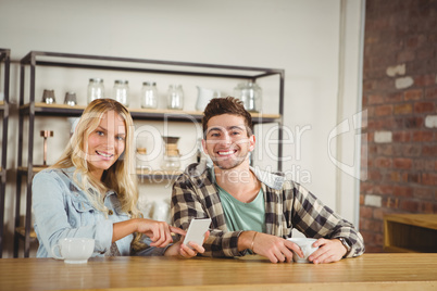 Smiling hipsters having coffee together