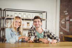 Smiling hipsters having coffee together