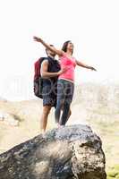 Young happy joggers posing on rock