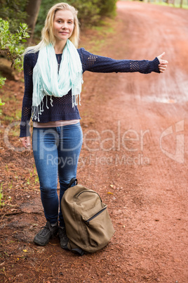 Pretty hitchhiker sticking thumb out