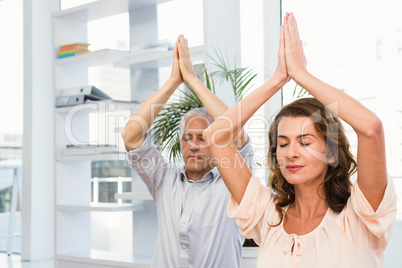 Peaceful casual business colleagues meditating