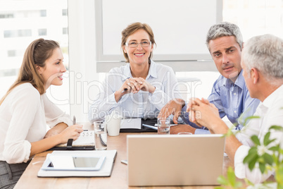 Smiling businesswoman with glasses in a meeting