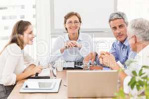 Smiling businesswoman with glasses in a meeting