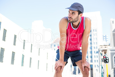 Exhausted athlete leaning forward after an effort