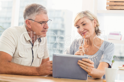 Smiling business team working over a tablet