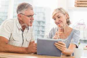 Smiling business team working over a tablet