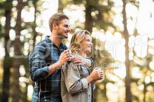 Happy smiling couple standing behind each other