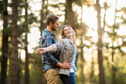 Happy smiling couple standing behind each other