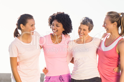 Laughing women wearing pink for breast cancer