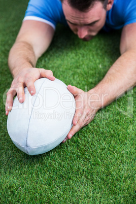Rugby player scoring a try