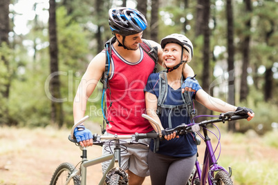 Happy young biker couple looking at each other