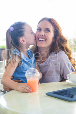 Mother and daughter at cafe terrace