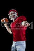 American football player throwing football