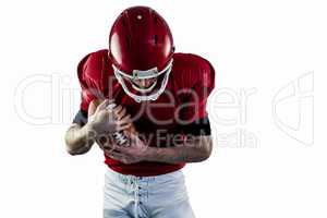 American football player protecting football