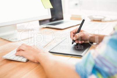 Graphic designer using computer and digitizer