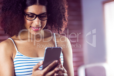 Happy hipster using her phone