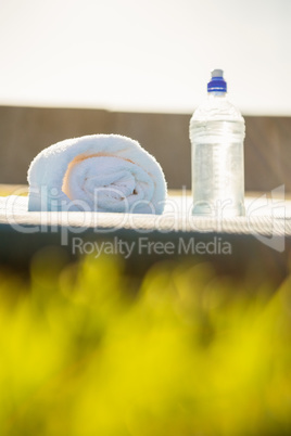 Water bottle and towel on exercise mat