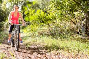 Blonde athlete mountain biking