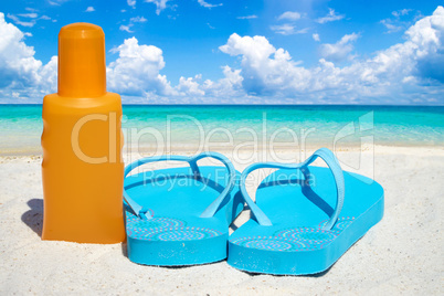 Flips Flops und eine Flasche Sonnenmilch am Strand