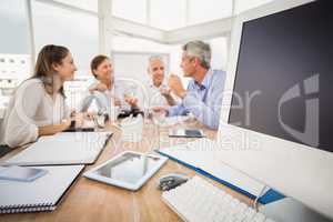 Electronic devices in front of talking business people
