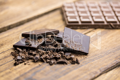 Pieces of chocolate on a wooden table