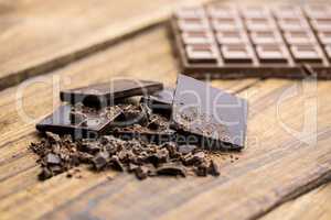 Pieces of chocolate on a wooden table