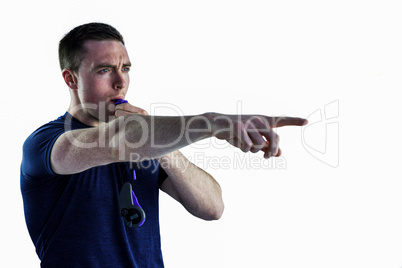 An attentive trainer blowing his whistle