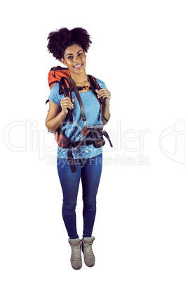 Portrait of a young woman with camera and backpack