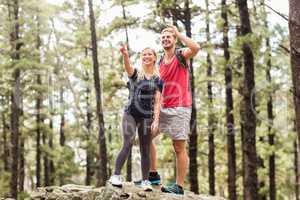 Young happy hiker couple looking away