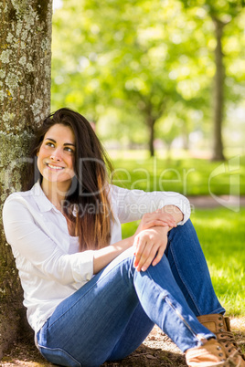 Beautiful brunette relaxing in the park