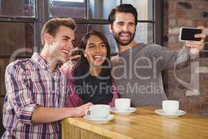 Group of friends looking at their smartphone