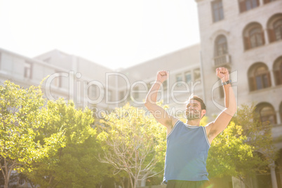 Happy handsome athlete triumphing