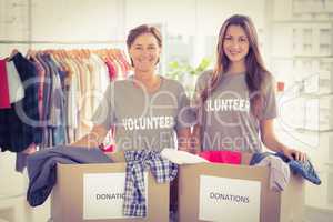 Concerned businesswomen with donation boxes