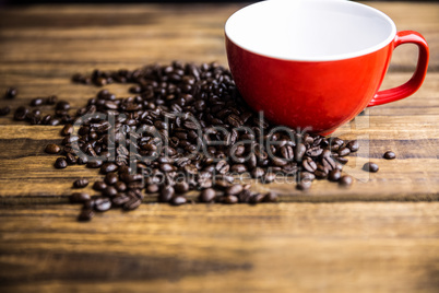 Coffee beans on a table with cup