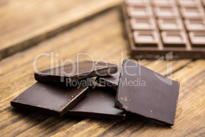 Pieces of chocolate on a wooden table