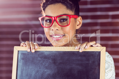 A female hipster holding a blackboard