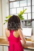 Beautiful casual businesswoman having a coffee using laptop