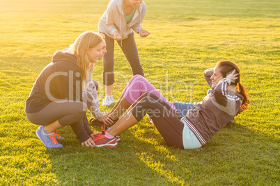 Sporty women doing sit ups during fitness class