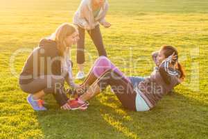 Sporty women doing sit ups during fitness class