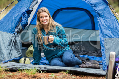 Portrait of a young pretty hiker lying in a tent